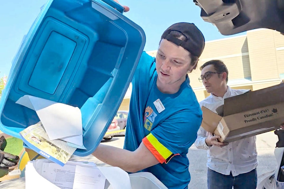 Cars lined up to unload documents for shredding at the  Senior Resources Society parking lot on Saturday, May 11, part of the organization’s annual by-donation disposal event. (Dan Ferguson/) 