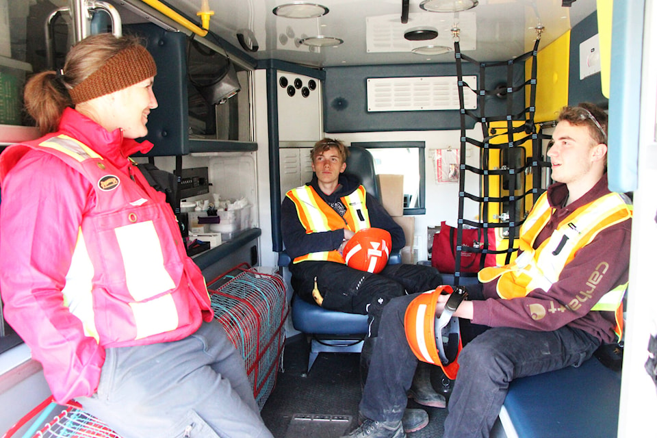 Alexa Jeffery from Combined Workplace Safety (left) tells Peter Skene Ogden Secondary School students Colin Wells and Felix Pavlik about some of the injuries she’s encountered in the workplace during the 2024 Heavy Metal Rocks. (Patrick Davies photo - 100 Mile Free Press) 