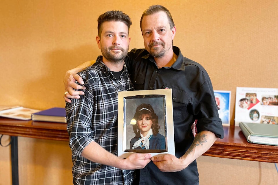 Nathan Myhr, left, and Jason Myhr, hold a photo of their mom, Cheryl Folden, from when she was young. (Ruth Lloyd photo - Williams Lake Tribune) 