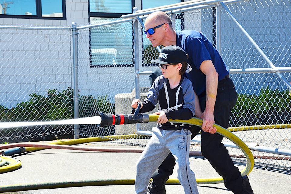 Dawson Carriere tries out the fire hose at at the Campbell River Fire Department Open House at the No. 1 Fire Hall on Saturday, May 11. Photo by Alistair Taylor/Campbell River Mirror 
