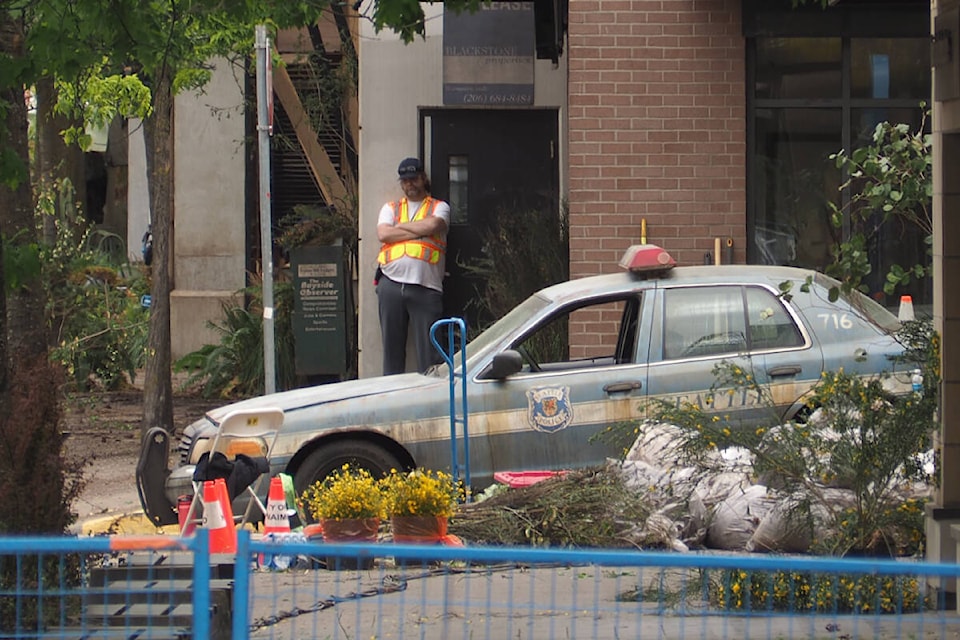 A derelict Seattle Police Department patrol car is positioned at the corner of Commercial Street and Museum Way in downtown Nanaimo for filming of ‘The Last of Us.’ (Chris Bush/News Bulletin) 