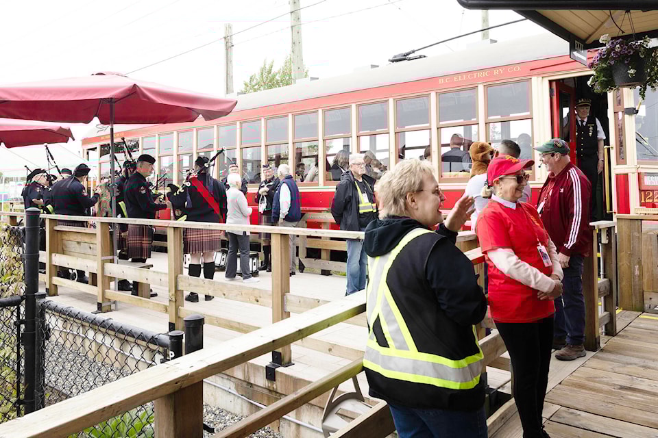 Visitors interact with members of the Surrey Firefighters Pipe and Drum band at Cloverdale Station in 2024. The railway summer music festival returns June 28 to the platform at Cloverdale Station. (Photo: Jason Sveinson) 