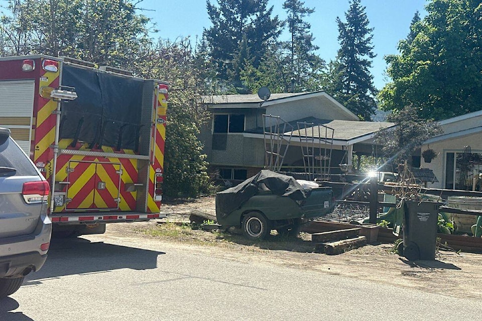 Police and RCMP tend to a house fire in Rutland, on Wallace Road in Kelowna. (Brittany Webster Photo) 