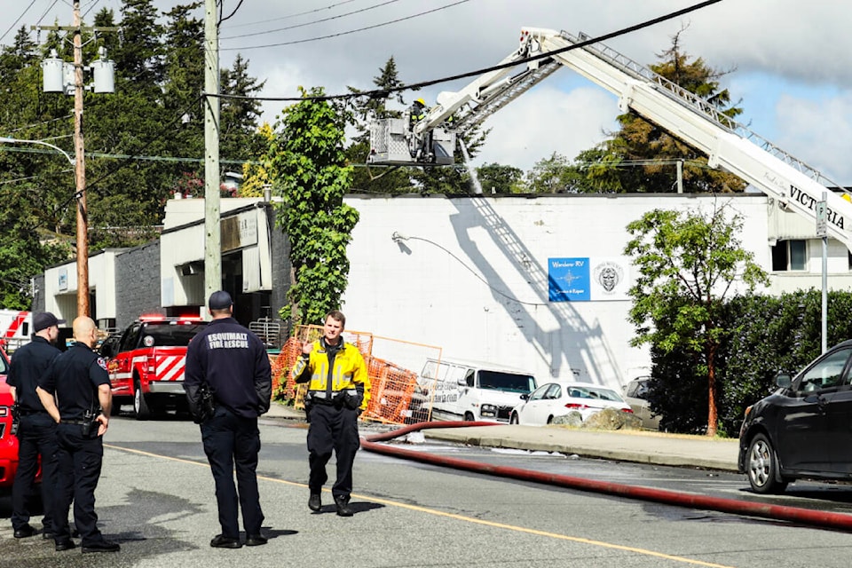 Esquimalt Fire Rescue douses the remnants of a bakery fire in Esquimalt on Wednesday (May 22). (Bailey Seymour/News Staff) 