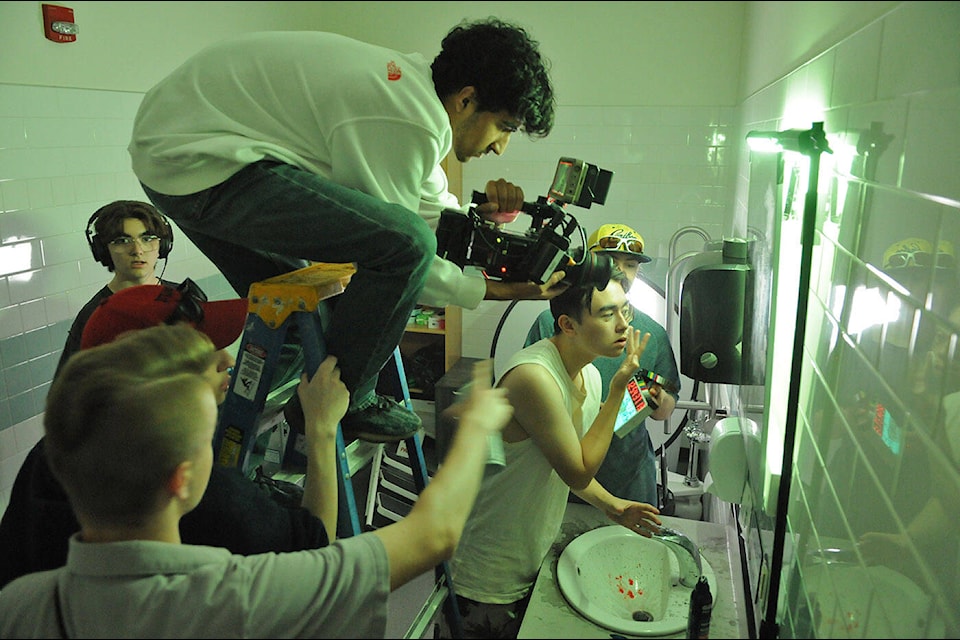 G.W. Graham Secondary School students film a scene from The Rat King inside a small bathroom as part of the school’s Film Production Workshop. (Jenna Hauck/ Chilliwack Progress) 