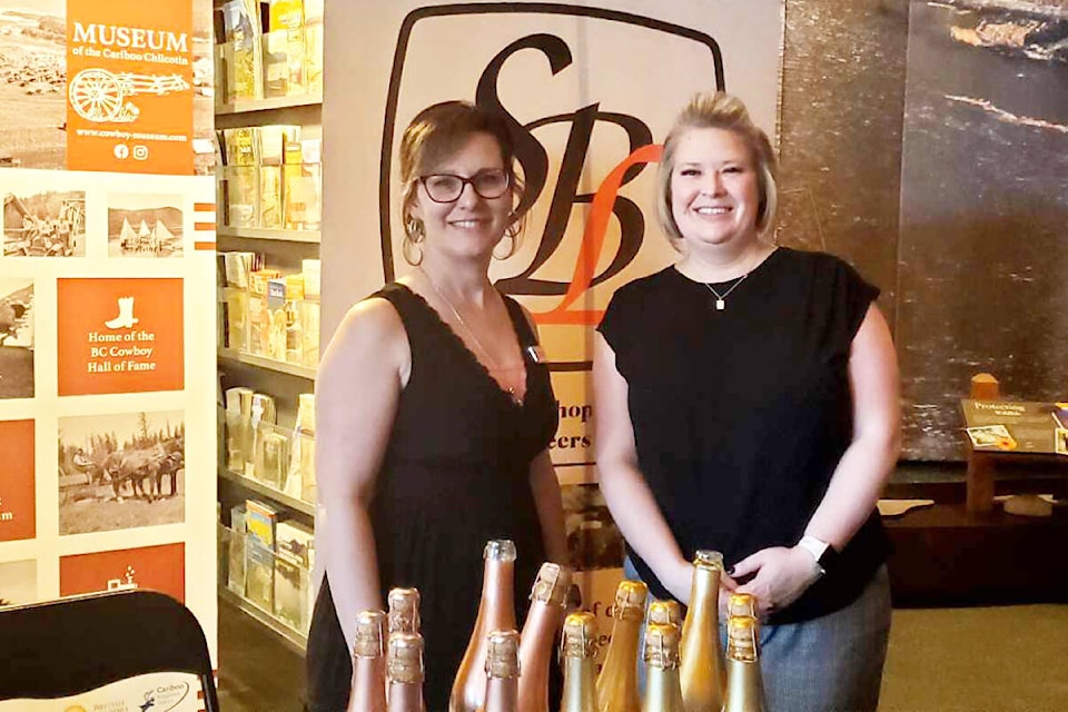 Williams Lake and District Chamber of Commerce executive director Tamara Garreau, left, and Ginni Faiburn of South Broadway Liquor who supplied 12 different wines for the wine festival. (Monica Lamb-Yorski photo - Efteen) 