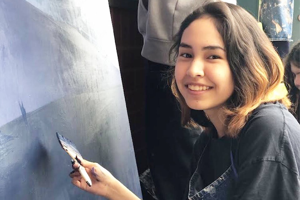 Leo Edwards, a Grade 10 artist in Ms. McCambridge’s drawing and painting class, works on a mural project the class is taking part in thanks to some funds from the Red Cross aimed at addressing climate anxiety in youth. (Siobhan McCambridge photo) 