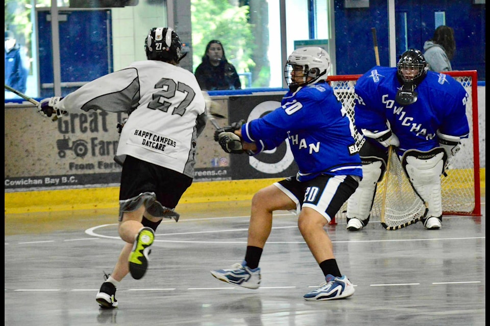 Cowichan’s Darren Seymour pressures the Westshore attacker while goalie Jackson Owen waits for a shot during the Thunder’s 11-7 victory May 21 at Kerry Park Arena. (Paula Harris photo) 