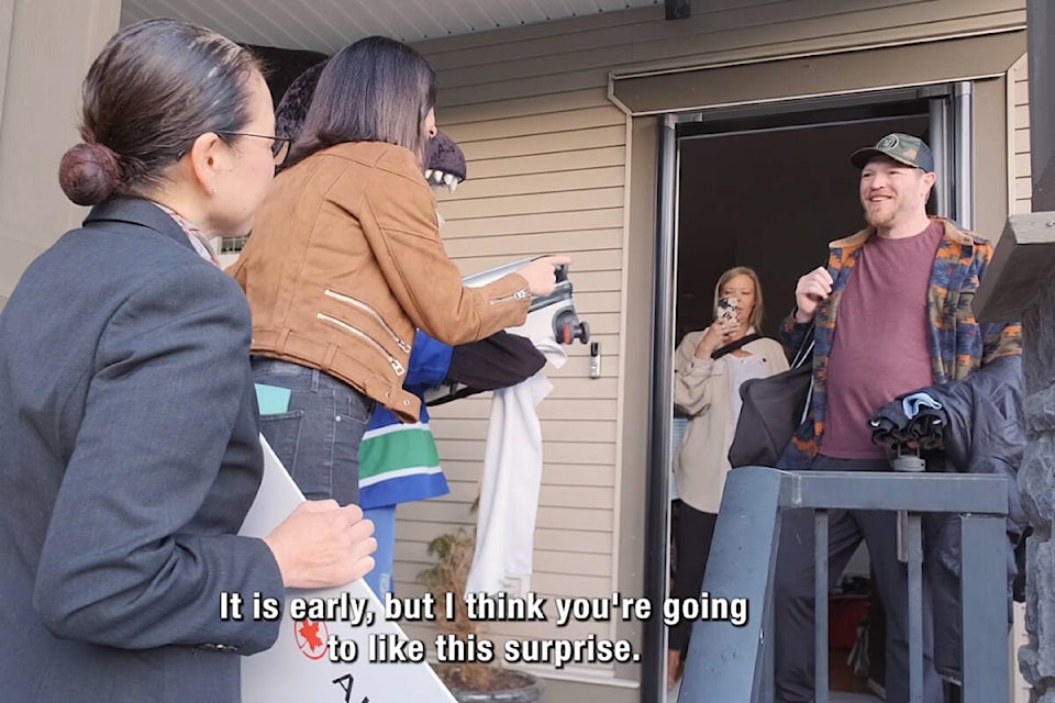 Sheldon Bailey is notified by the representatives from the Vancouver Canucks and Air Canada that he is going to Edmonton to see Game 3 of the Canucks-Oilers playoff series. (Screenshot from video) 