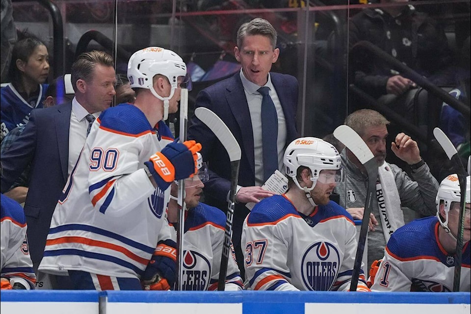 The morning before Game 4 of the Western Conference final, veteran Edmonton Oilers forward Corey Perry was informed that his five-game exile to the press box was ending. Edmonton Oilers head coach Kris Knoblauch, back centre, talks to Perry (90) during the first period in Game 1 of NHL hockey Stanley Cup second-round playoff action against the Vancouver Canucks, in Vancouver, Wednesday, May 8, 2024. THE CANADIAN PRESS/Darryl Dyck 