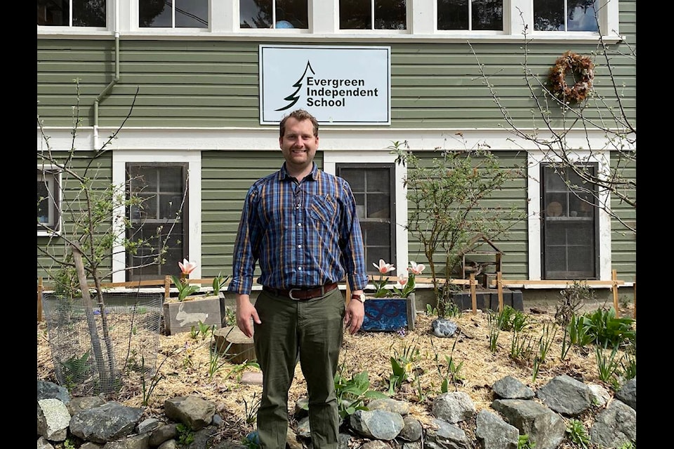 Originally from the U.K. Lucien Power started with Evergreen Independent School in 2021, where he first worked in inclusive education and as an EA. In his second year he took on the role of vice-principal and is now in his first year as school principal. Power stands in front of school and a garden that the students had a hand in creating. (Chadd Cawson/Connector) 