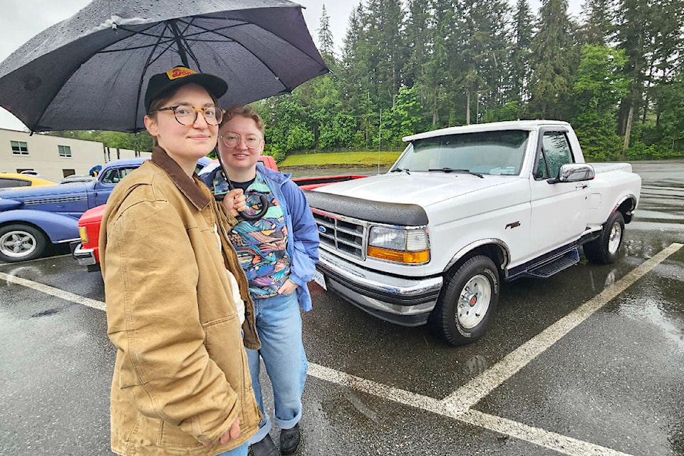 Brookswood residents Angela Hollister (left) and Marlee Grant explained how they had washed Hollister’s lovingly restored 1994 Ford pickup truck for the show, only to have the rain keep pouring down on the actual day of the event, Saturday, May 2. (Dan Ferguson/) 