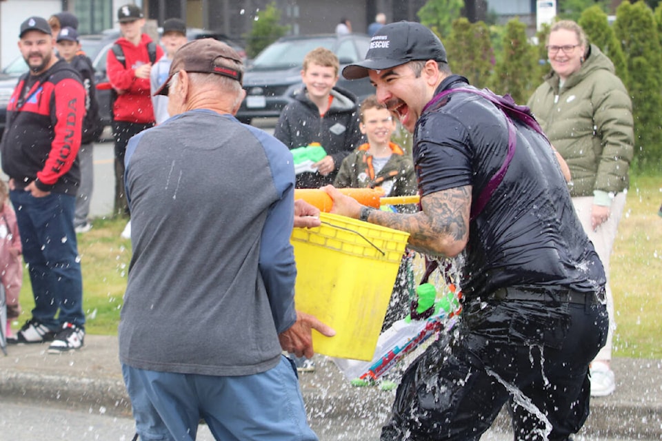 Members of Pitt Meadows Fire and Rescue had their traditional water fight with kids and adults alike to end the Pitt Meadows Day parade. (Brandon Tucker/The News) 