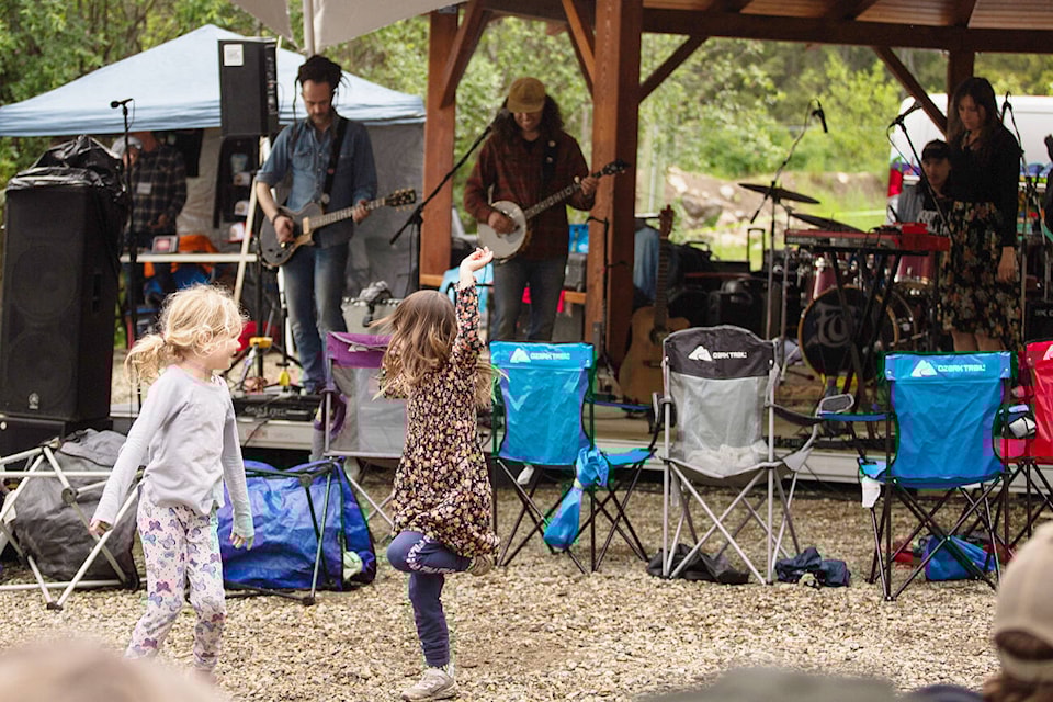 Austin Gilbank and Wynn Nahm brave the wet weather to dance together to the music of Shred Kelly during the Shuswap Trail Alliance’s B.C. Trails Day Celebration at the South Canoe trailhead on Saturday, June 1, 2024. (Kayleigh Seibel Photography) 
