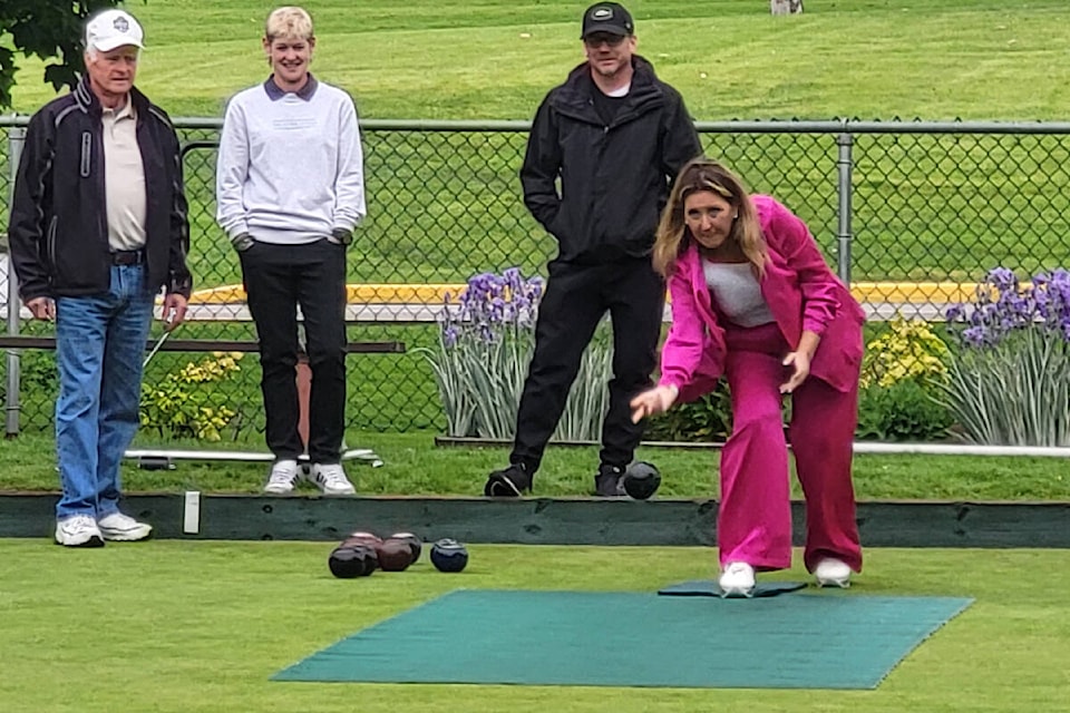 Michelle Dallyn (right) is the picture of concentration as she delivers her bowl while opponents Leon MacAulay (from left), Tish Scott, and Shawn Coleman wait their turn Monday, June 3, at the Vernon Lawn Bowling Club. The event was part of the kick-off to Seniors Week in Vernon. (Roger Knox - Morning Star) 
