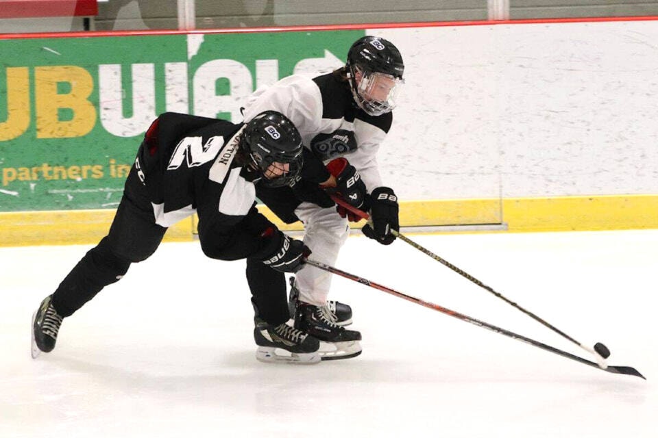 Vernon’s Carter Hutton (black) battles for the puck with Kelowna’s Ryan Sadovia during play at the inaugural UMH 68 Invitational Tournament in 2023. (Bowen Assman/Morning Star) 