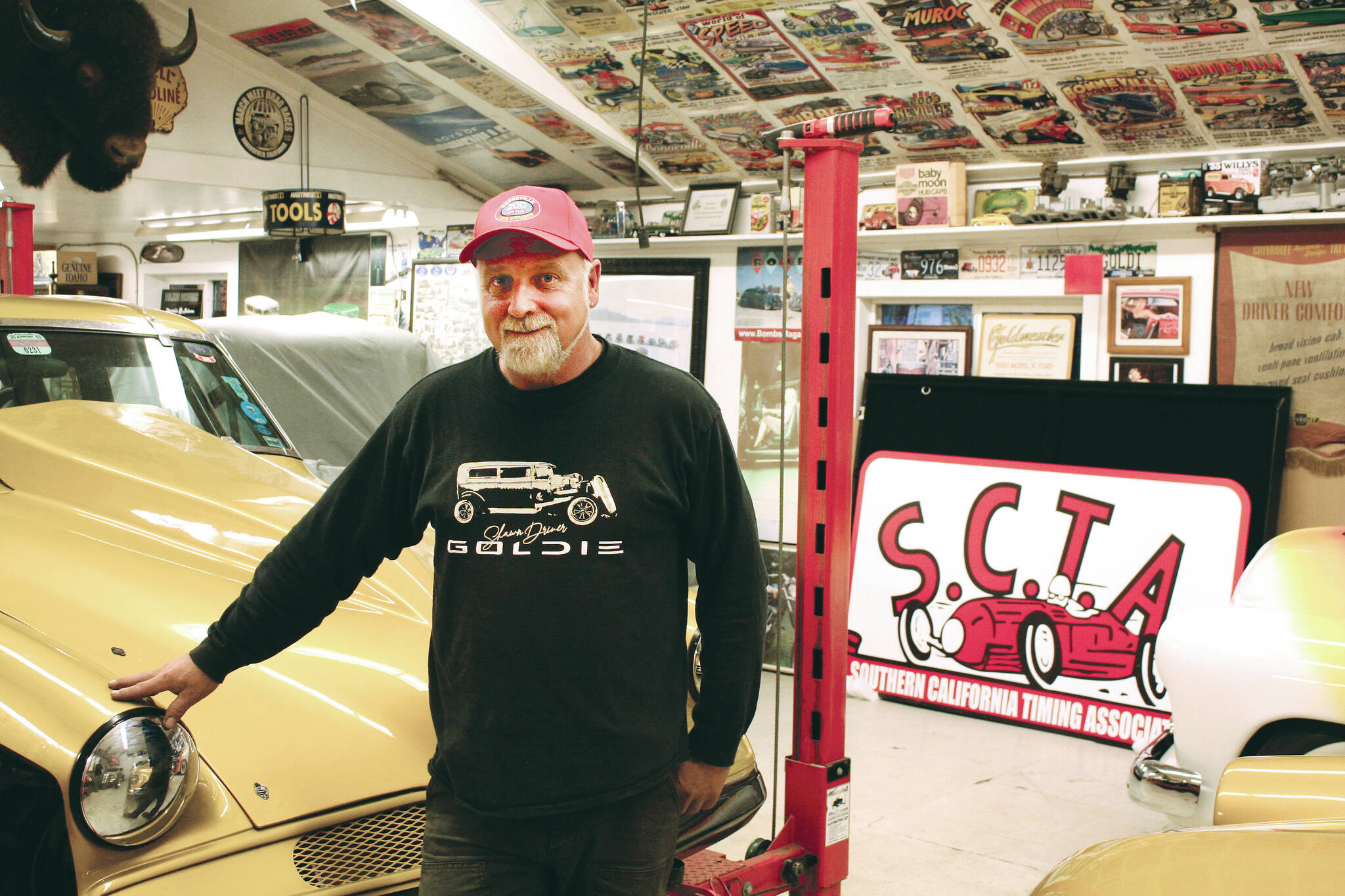 Shawn Driver proudly stands next to his car in his Sooke shop. (Bailey Moreton - Sooke News Mirror)