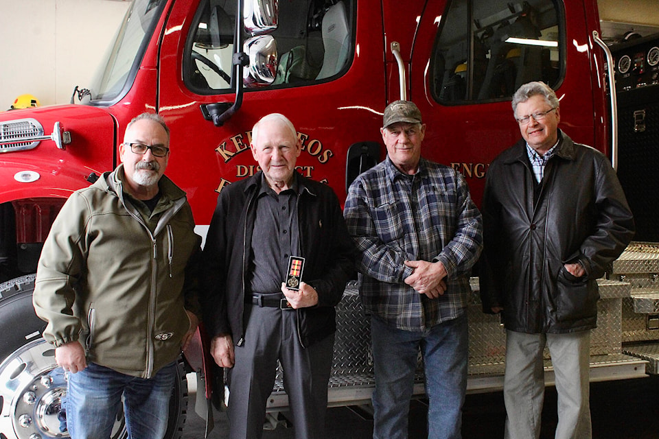 Retired firefighter Red Bosscha, middle left, was presented with the Canadian Volunteer Firefighter Services Association Medal for over 40 years of service at a recent dinner. RDOS directors Tim Roberts, left, and George Bush, middle right, presented the award alongside acting Keremeos Mayor Arden Holly, right. (Submitted)