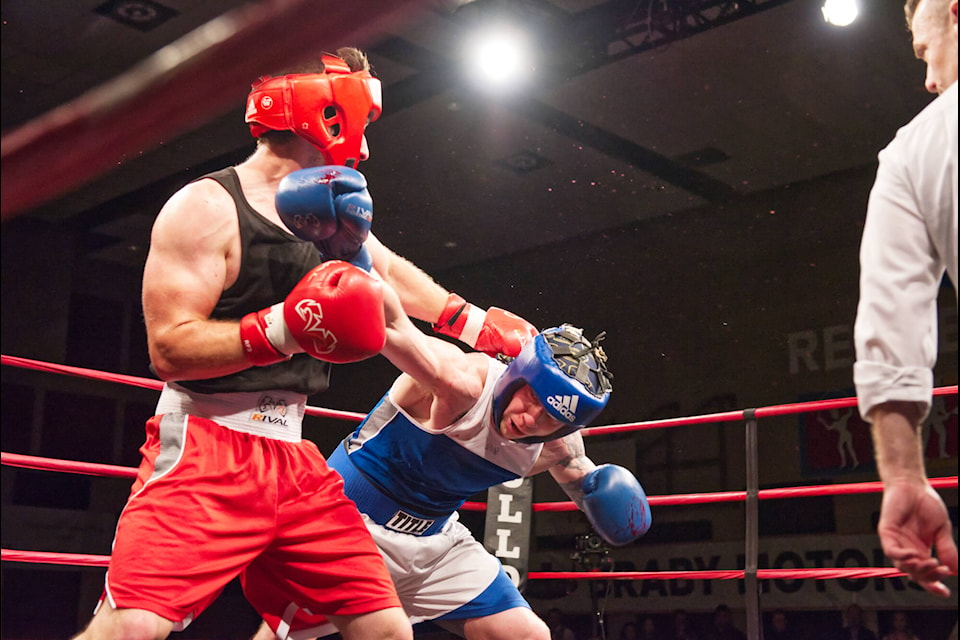 Jordan Barin of Salmon Arm’s Bulldog’s Boxing dodges a blow while connecting with the chin of opponent Tyson Chamberlain, of the Kamloops Boxing Academy, in a novice elite bout. Barin dominated the fight and was declared the winner during the Hit2Fit fundraising event at the SASCU Recreation Centre on Saturday, May 7, 2022. (Lachlan Labere-Salmon Arm Observer)