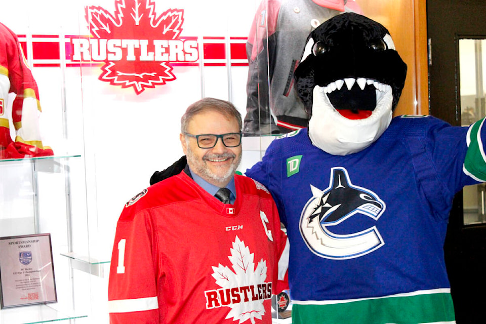 Maple Ridge Mayor Dan Ruimy posed with Fin, the Vancouver Canucks mascot, for a Kraft Hockeyville promotional video at Planet Ice. (Brandon Tucker/The News)