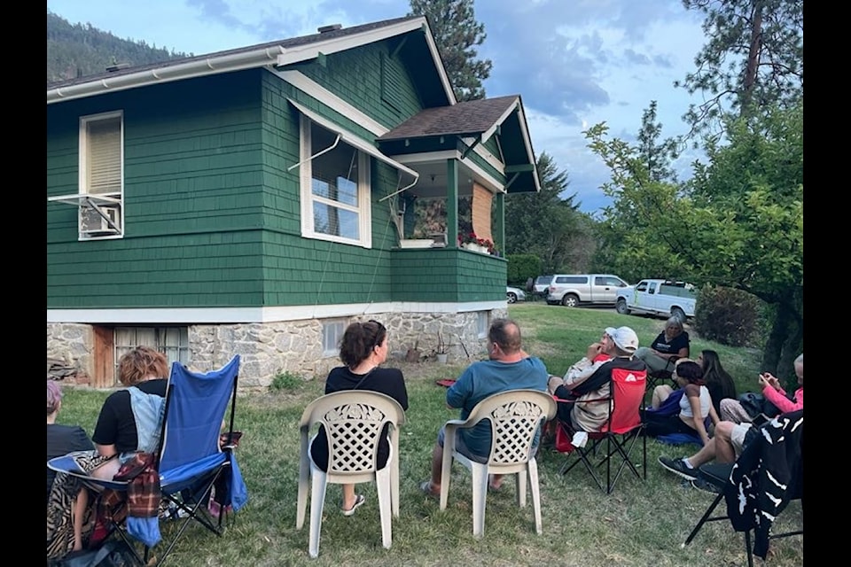 Volunteers ready to start counting bats that will emerge from the gable vent of a home near
Vernon. These conservation-minded homeowners manage their house to safely allow the bat colony to live in the attic