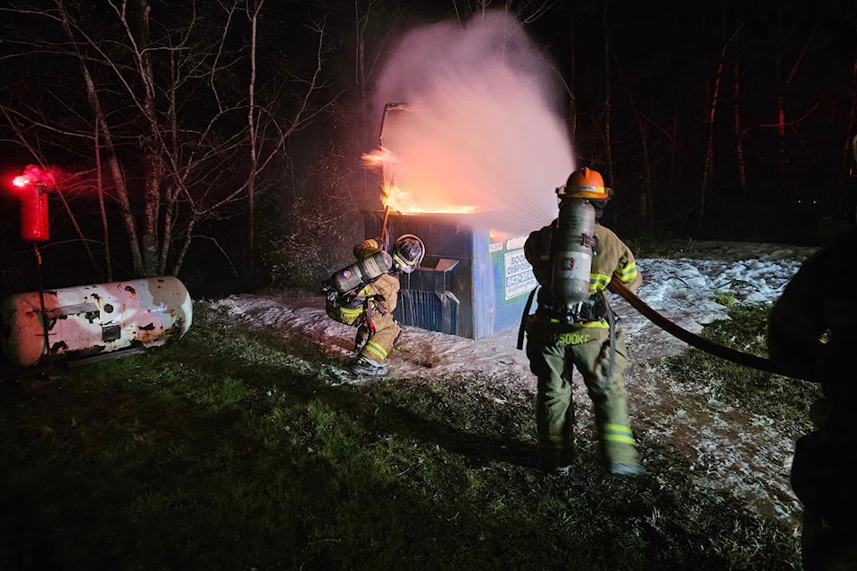 East Sooke firefighters tackle an intentional dumpster fire Nov. 28 as part of their job training requirements. 