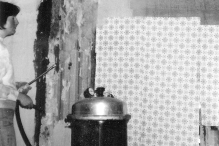 Vivian Jubb cleaning wallpaper at Moss Cottage on West Coast Road in 1977. (Sooke Region Musem photo)