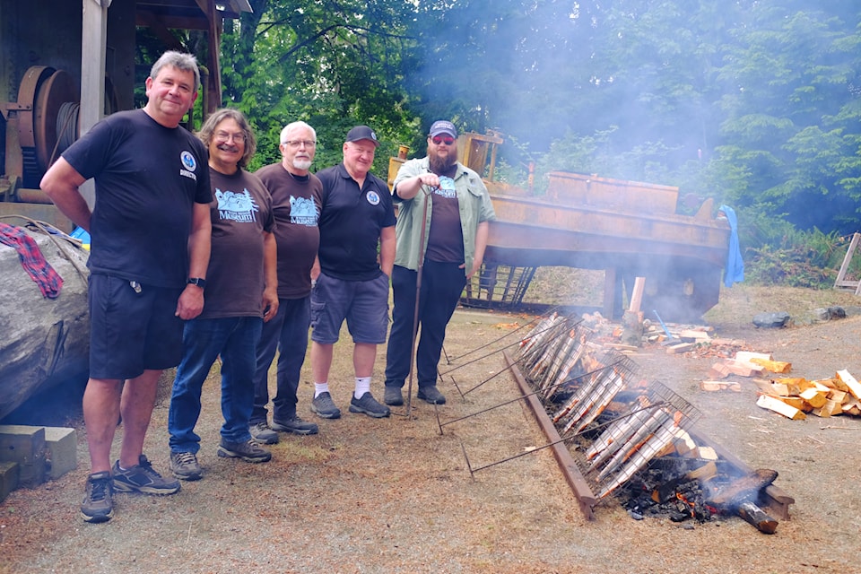 Dean Haldane (left) and his extended family serve as the pitmasters behind the salmon barbecue.