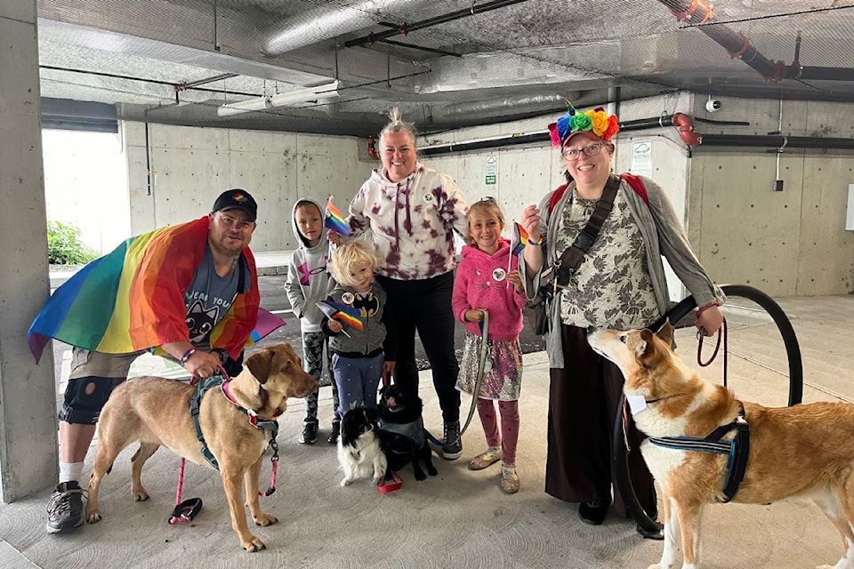 Participants and their pups come together at last years Paws for Pride Parade.