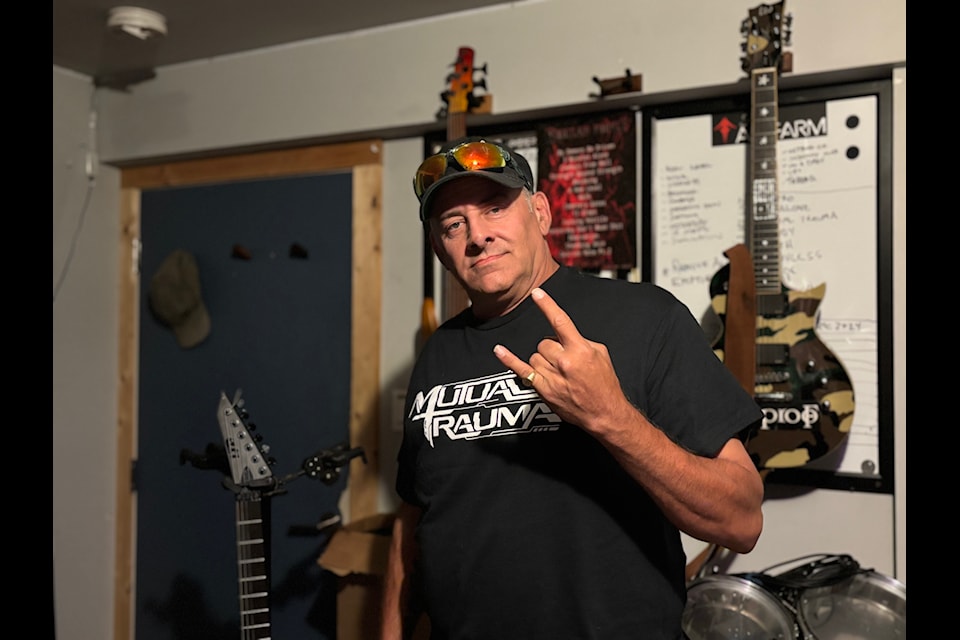 Royal Savoie, the organizer of Mosh the Rock Island Metalfest, stands in Stefano's Art Farm, a local recording studio.