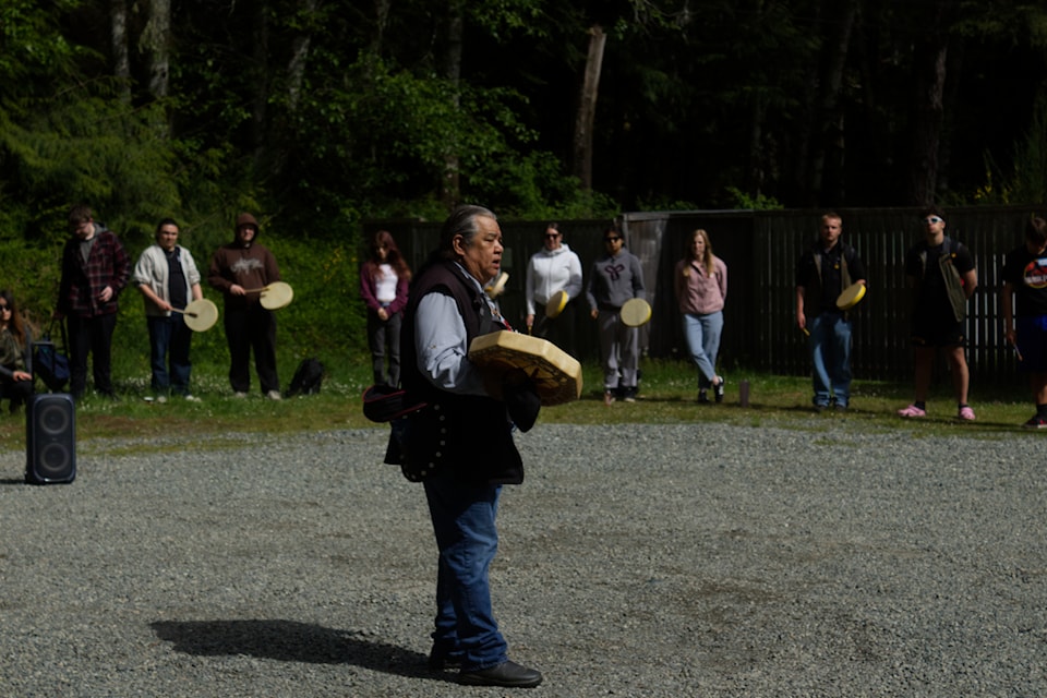 Brother Rick leads students in song.