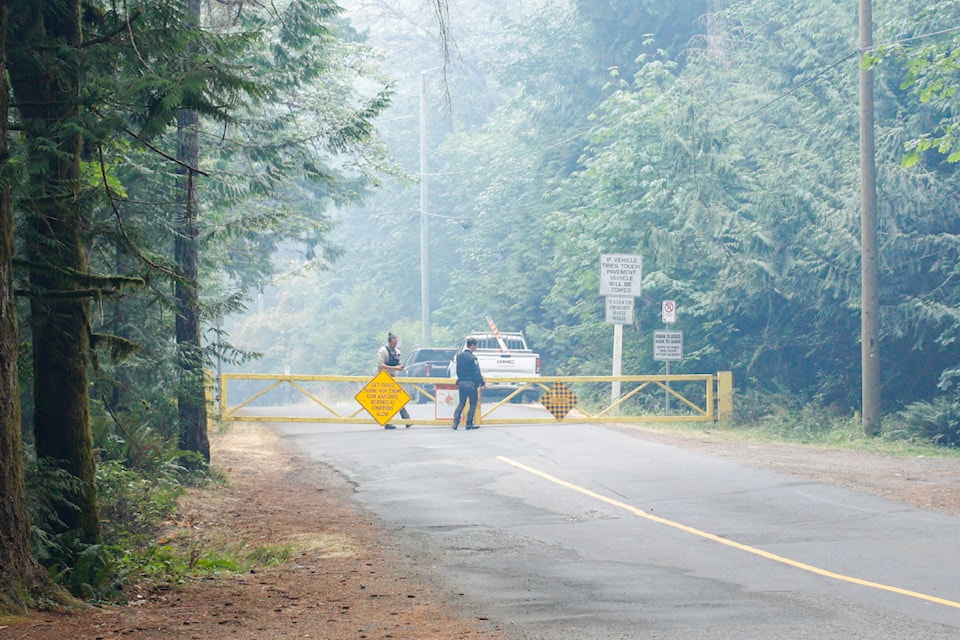 CRD staff have a roadblock on Sooke River Road as a wildfire continues to rage North of Sooke