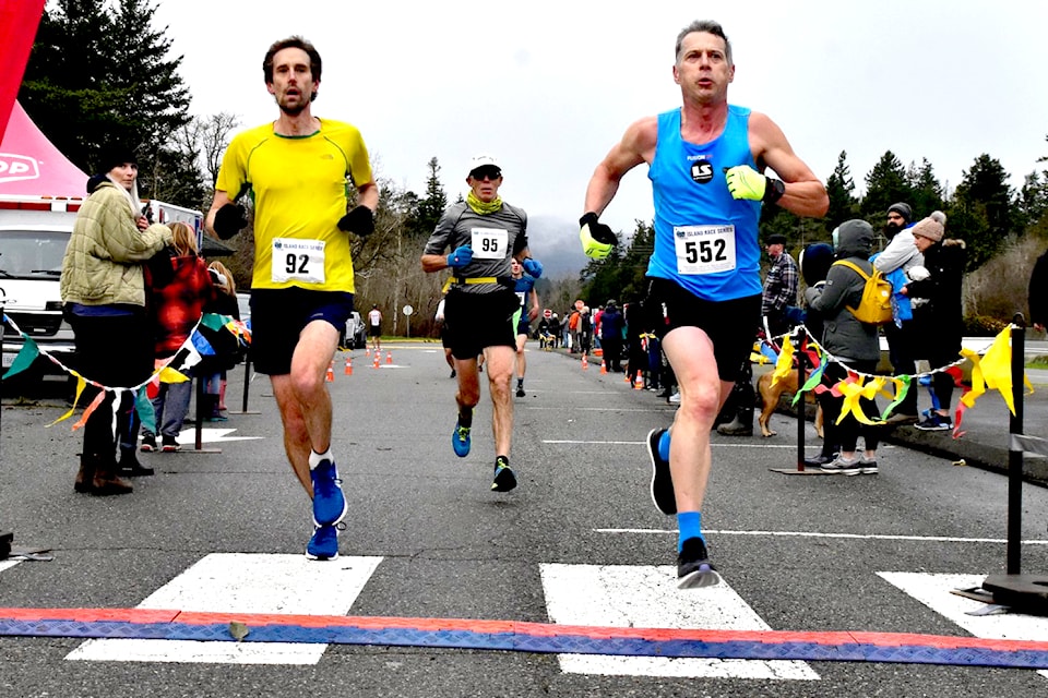 Two runners compete in the Harriers Pioneer 8K Road Race on Sunday, Jan. 12, 2020. This year's race marks the start of the Vancouver Island Race Series and the 46th annual Harriers event. (Joseph Camilleri photo)