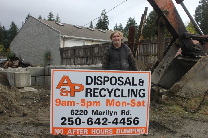 91254sookeSH-A-Pdisposal-PatrickWeston-co-ownerofA-PDisposal-Recycling-holdsupsignageatthesiteofthenewtransferstationon6220MarilynRd