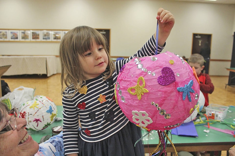 LANTERN FUN Three-and-a-half-year-old Jenna MacMillan shows off the lantern she decorated during a lantern making workshop at the Royal Canadian Legion Prince Edward Branch on Tuesday. The workshop was held in anticipation of the Light up the Hills festival, a family-friendly outdoor festival of light on Saturday, Sept. 23 from 7:30 to 9:30 p.m. at Westhills. (Kendra Wong/News Gazette staff)