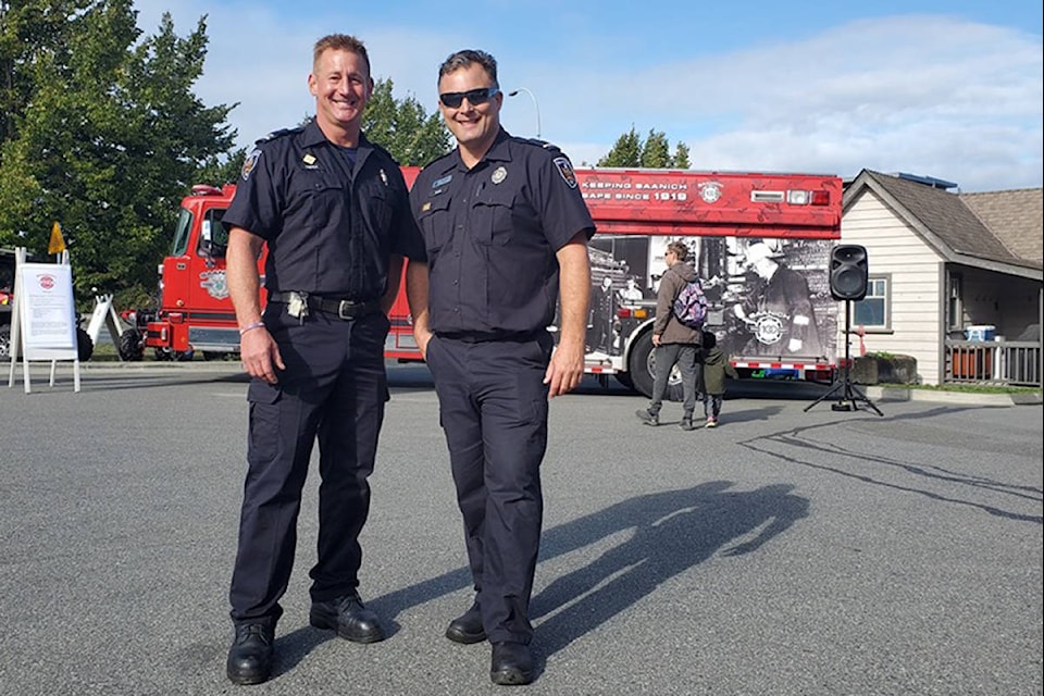Firefighters, Carl Trepels and Sean Lillis celebrated the 100th anniversary of the Saanich Fire Department on Saturday. (Jessica Williamson/News Staff)