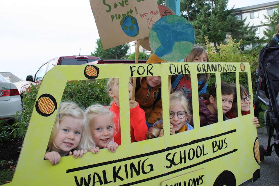 To Willows, and beyond, a group of Willows students and their younger siblings took the Walking School Bus along Fort Street/Cadboro Bay Road on Tuesday morning in support of Climate Action Week. At the front of the bus are Isla and Nora, Lily Clancy, Kingston Goodhew, Ivy Clancy, Anna Davison, Emma Bristow and Clara Davison. (Travis Paterson/News Staff)