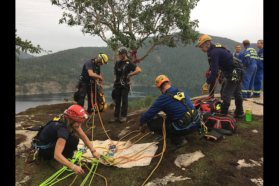 The Cowichan Search and Rescue team prepares to head down the cliff face at Stoney Hill to try to find dog Frankie. (Warren Goulding/Citizen)