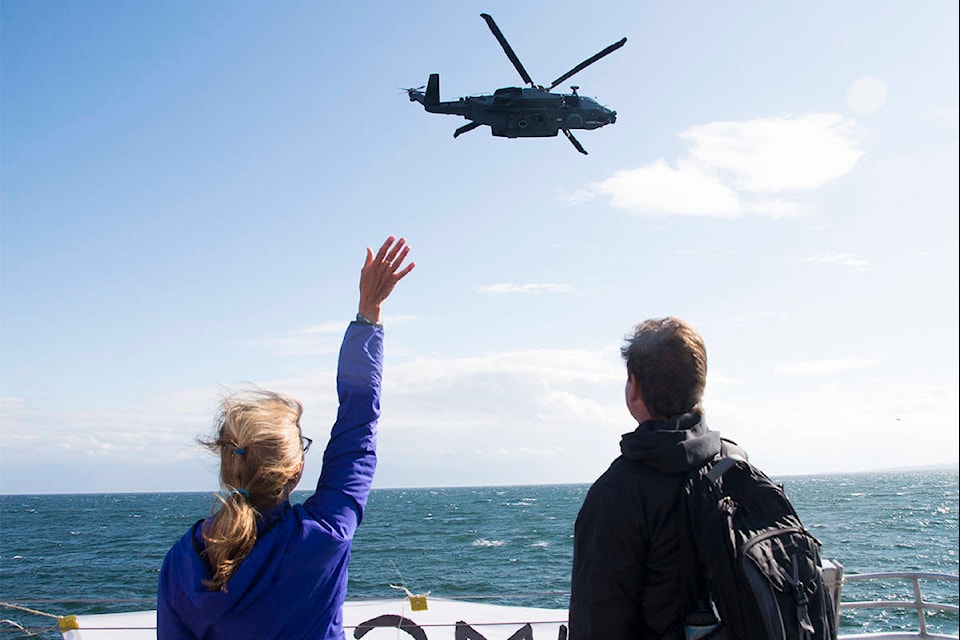 Lynda and Glenn Neumann wave to son Sam, a leading seaman in the Royal Canadian Navy Task Group sailing to the Rim of the Pacific Exercise and other operations in the western Pacific Ocean. The couple held a huge sign over the railing at Ogden Point reading, “HCMS Winnipeg Sam.” (Nina Grossman/News Staff)