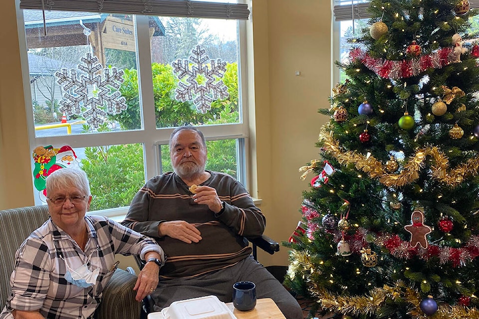 Ayre Manor residents Terry and his wife Dawn eating some snacks at the annual Christmas party. (Supplied by Ayre Manor)