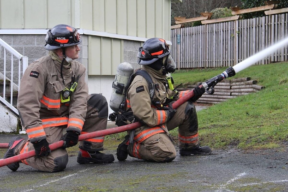 Firefighters Chris Bailey, left, and Nicole Pound hit the training ground in Oak Bay. (Christine van Reeuwyk/News Staff)