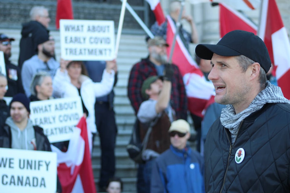 Christopher Johnson, a rally attendee, helps to direct people at the B.C. legislature on March 5. (Megan Atkins-Baker/News Staff)