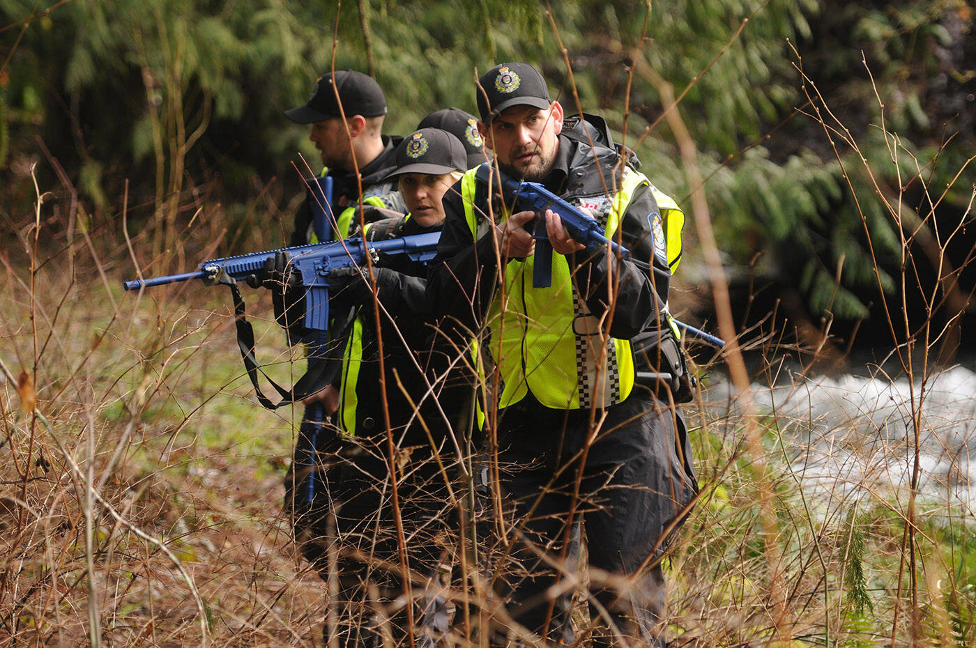 Conservation officers move in a tactical diamond formation while taking part in a wildlife attack training scenario in Chilliwack on Thursday, March 3, 2022. (Jenna Hauck/ Chilliwack Progress)