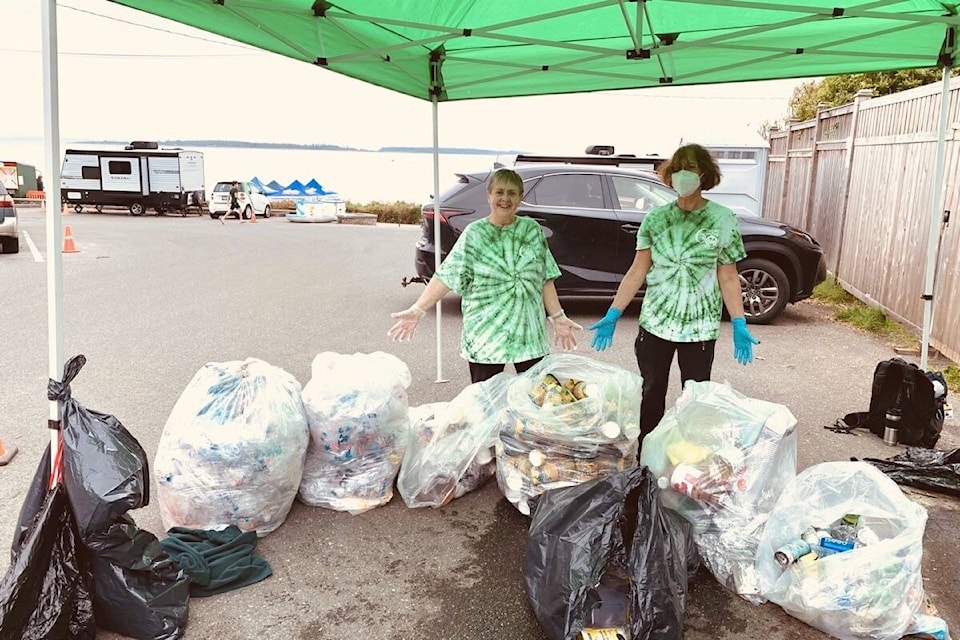 A small team of volunteers sorts the trash during the Oak Bay Tea Party. This year yielded seven bags each of soft plastics, hard plastics, compost and garbage. (Photo by Ron Carter)