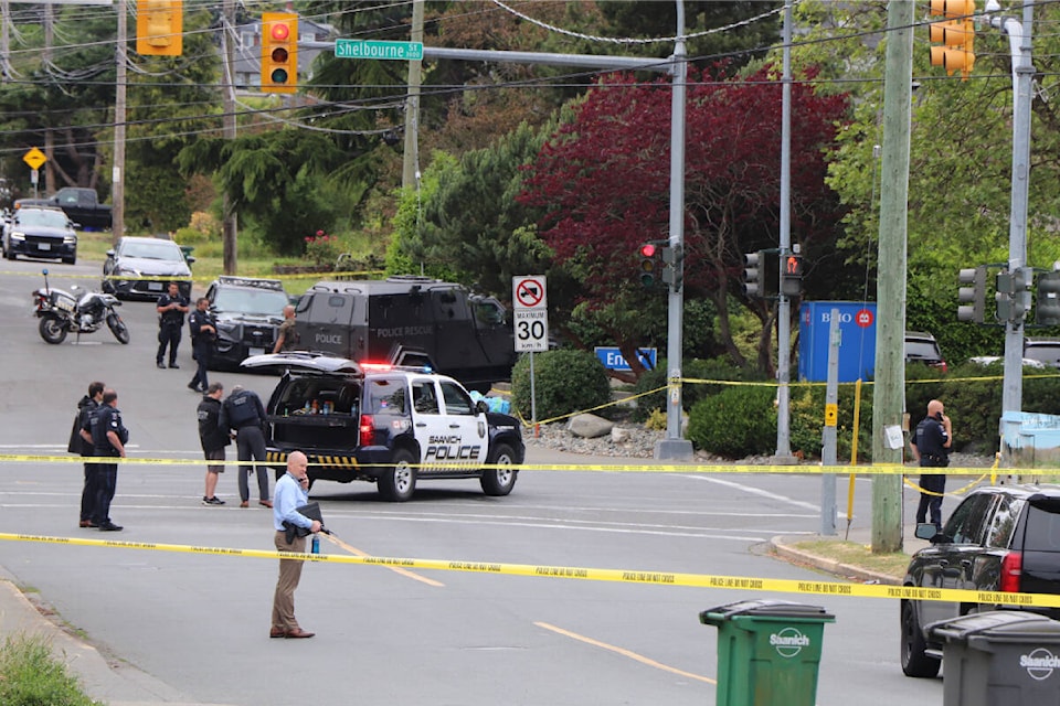 Police personnel surround the area around the BMO branch at Shelbourne and Pear streets in Saanich. A midday bank robbery there was followed by a shooting that left two suspects dead and saw six police officers taken to hospital with gunshot wounds. (Don Descoteau/News Staff)