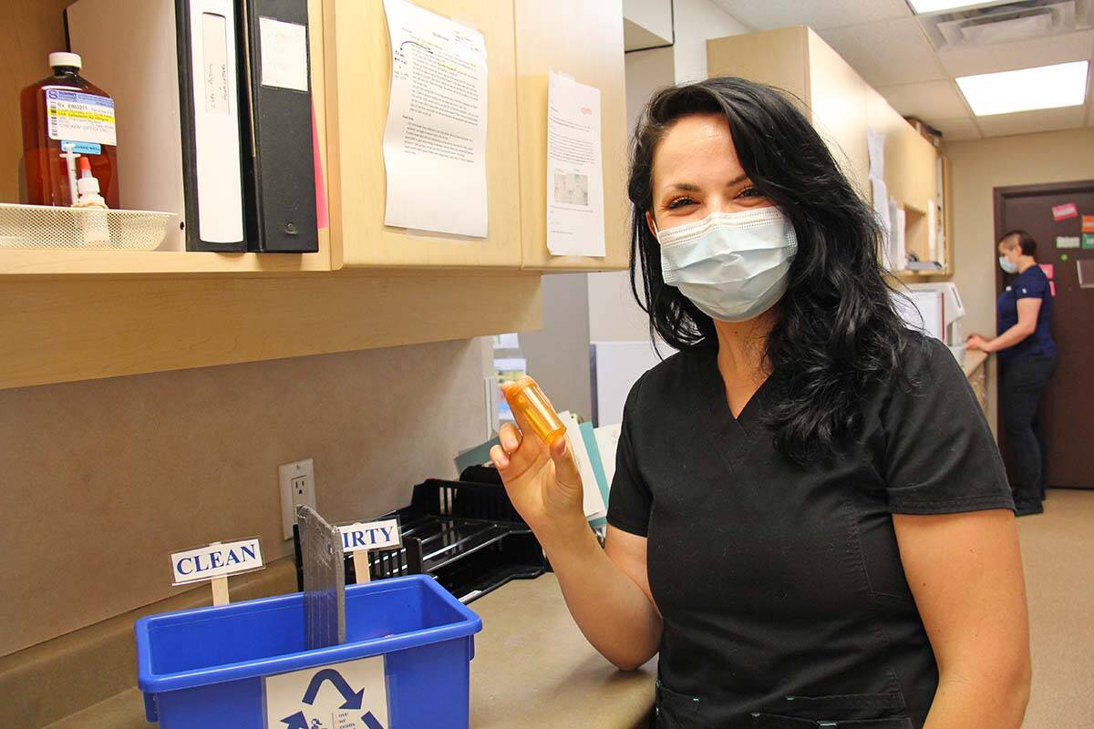Burnaby vet technician Jocelyn Marsh shows off part of her pill bottle return program. (Jane Skrypnek/Black Press Media)