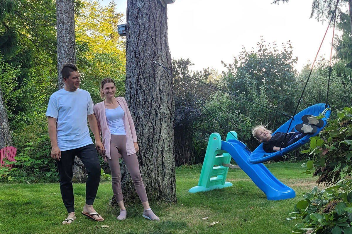 Valerii and Anastasiia Didenko are with their five-year-old daughter, Nikol, who is playing on a swing at the North Saanich couples home the family has been staying at since May 31. (Black Press Media)