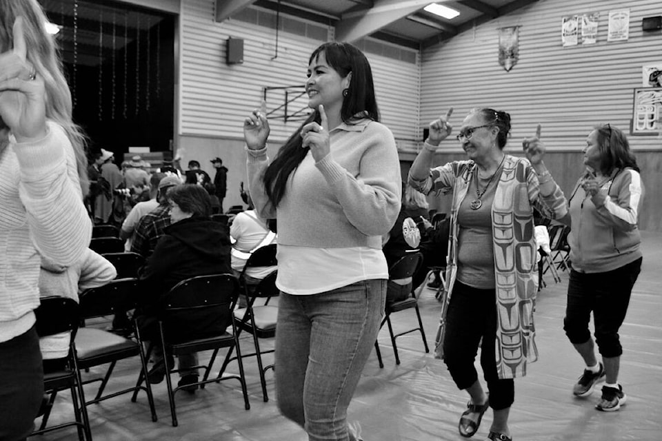 Anna Atleo dances with Rebecca Atleo, right, during an announcement ceremony on Aug. 10 in the Maaqtusiis School Gym. (Nora O’Malley photo)