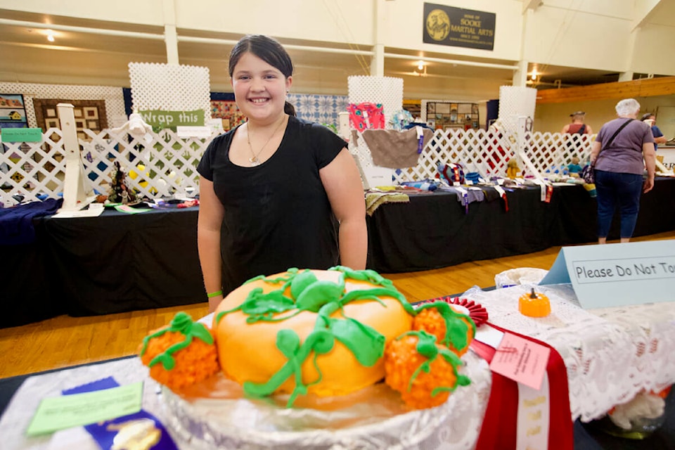 Dahlia Billings stands with her first prize-winning cake Saturday at the Sooke Fall Fair. (Justin Samanski-Langille/News Staff)