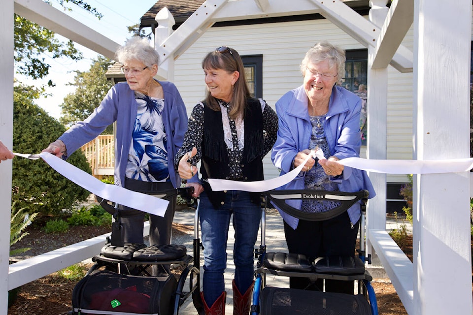 From left: Isabel Tipton, great-granddaughter of Hans Helgesen, the first chairman of the school board; Ann Stewart, great-great-granddaughter of John Witty who donated the land for the school to be built on; and Diane Cowden, great-granddaughter of Emily Fisher, the school’s first teacher. The trio received the honour of cutting the ribbon on the newly renovated and reopened Metchosin Schoolhouse Museum. (Justin Samanski-Langille/News Staff)